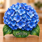 Digital preview of a blue hydrangea subject-shaped acrylic plaque with ADELINE on its lowest illustrated green leaf