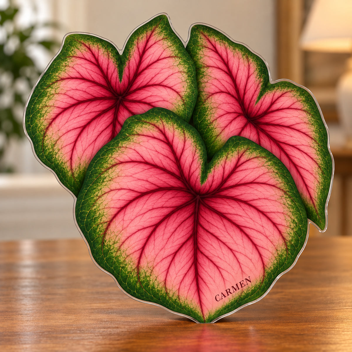 Digital preview of a rose-pink caladium-shaped acrylic plaque with CARMEN integrated along its lowest illustrated leaf