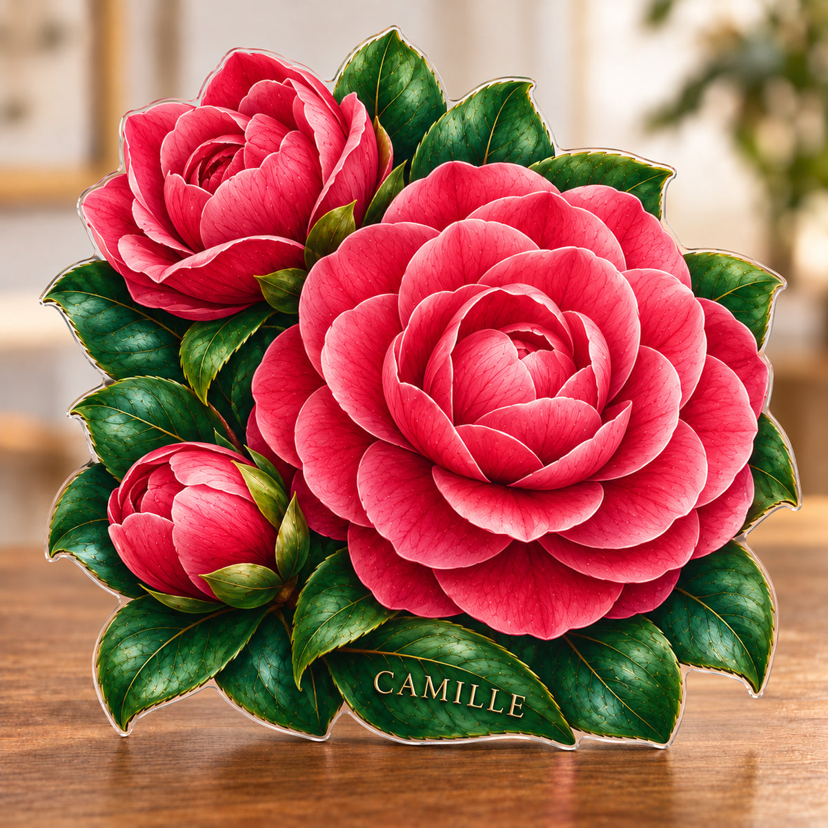 Digital preview of a camellia-shaped acrylic plaque with CAMILLE integrated along its lowest illustrated emerald leaf