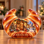 Front-view digital preview of a Christmas amber croissant acrylic plaque with example name BRIOCHE integrated into the lowest pastry body facets