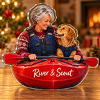 Front-view digital preview of a Christmas kayaker dog companion acrylic plaque with example name River & Scout integrated into the illustrated kayak hull name panel