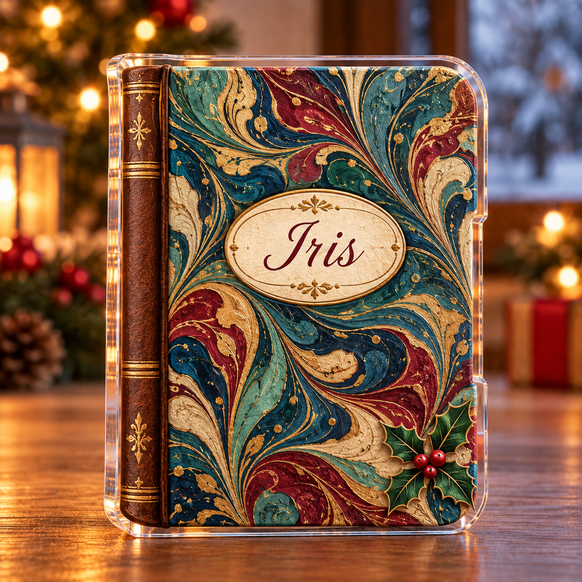 Front-view digital preview of a Christmas paper marbling journal acrylic plaque with example name Iris integrated into the journal front oval name label