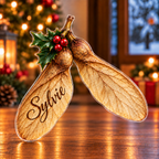 Front-view digital preview of a Christmas sycamore winged wish acrylic plaque with example name Sylvie integrated into the broad near seed wing