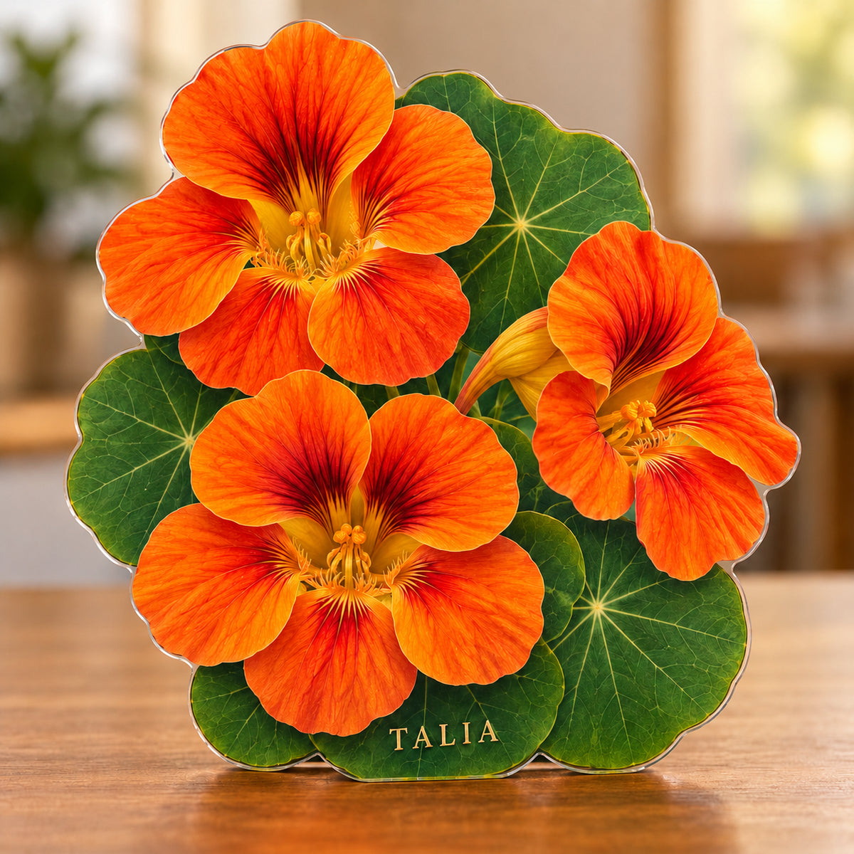 Digital preview of an orange nasturtium-shaped acrylic plaque with TALIA integrated along its lowest illustrated leaf