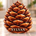 Front-view digital preview of a amber pine cone subject-shaped acrylic plaque with SYLVAN printed on its lowest intrinsic illustrated cone scale