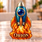 Front-view digital preview of a retro teal rocket subject-shaped acrylic plaque with ORION printed on its lowest intrinsic illustrated flame surface