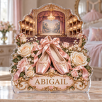 Front view of a ballet slippers rose theater custom-shape acrylic plaque with example name ABIGAIL, displayed in a softly blurred elegant dance-inspired bedroom on pale stone console