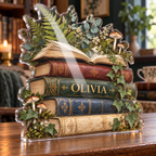Artwork visualization: Botanical book stack — quiet corner decoration, personalized OLIVIA, subject-shaped acrylic with printed optical 3D depth; not carved relief.