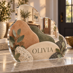 Artwork visualization: Organic pebble shapes — personalized housewarming, personalized OLIVIA, subject-shaped acrylic with printed optical 3D depth; not carved relief.