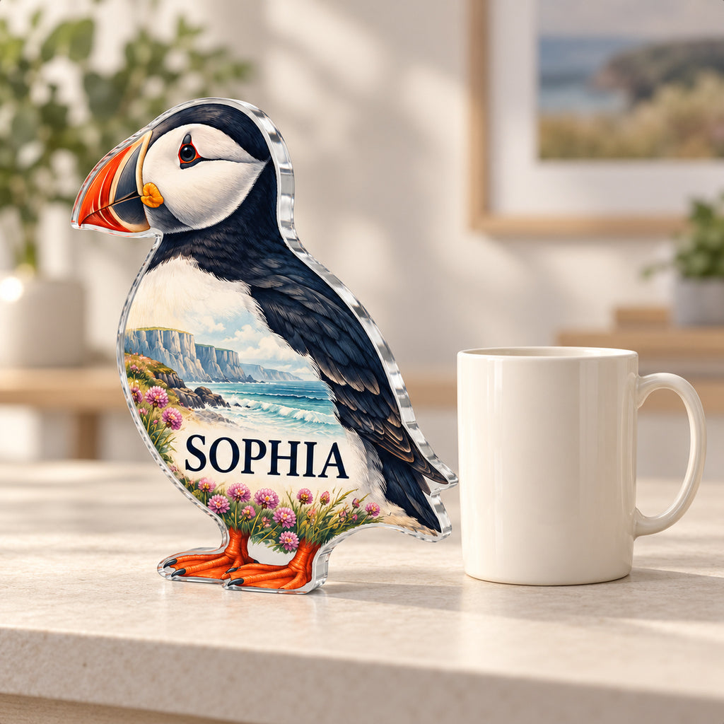 Personalized puffin acrylic plaque shown next to a plain ivory mug for size